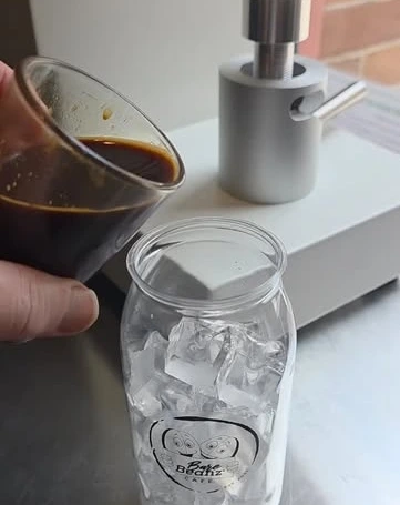 Bare Beanz coffee being prepared over ice