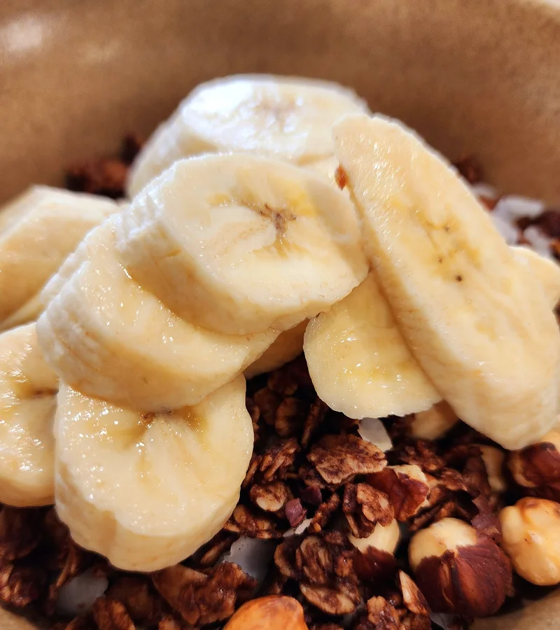 Granola topped with banana at Bare Beanz